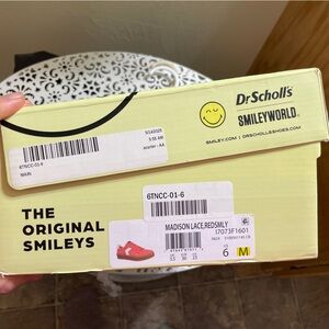 Tennis shoes coral with a smile face.